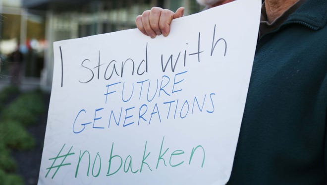 People representing Iowa Citizens for Community Improvement, the Bakken Pipeline Resistance Coalition and the Food Sovereignty Alliance gather outside of the Iowa Utilities Board office to protest the Bakken Pipeline on Thursday, Oct. 15, 2015, in Des Moines. The group delivered more than 1,000 objection to the pipeline to the utilities board.