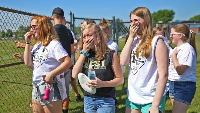 Students of Noblesville West Middle School science teacher Jason Seaman become emotional as they get ready to see him, over a fence, at the IHSAA baseball championships, the Noblesville vs Hamilton Southeastern game, Monday, May 28, 2018.  This is the first time the students have seen their teacher since Friday May 25's school shooting.  When a student opened fire in the seventh grade science classroom, Seaman intervened to stop the shooter from shooting more students.  He and one student were shot in the incident.  He was shot three times.  He told the students he couldn't hug them just yet, because he was still a little tender, but he could high five them.