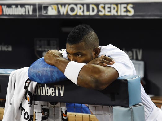 Yasiel Puig looks on from the dugout after Game 7.
