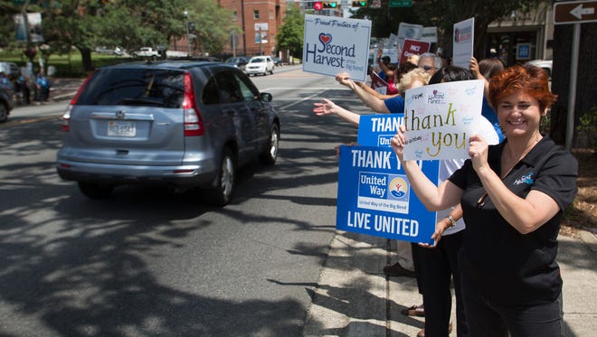 The United Way of Big Bend's partners lined the sidewalks of South Monroe street waving signage with messages of gratitude for local community supporters on May 9, 2016.