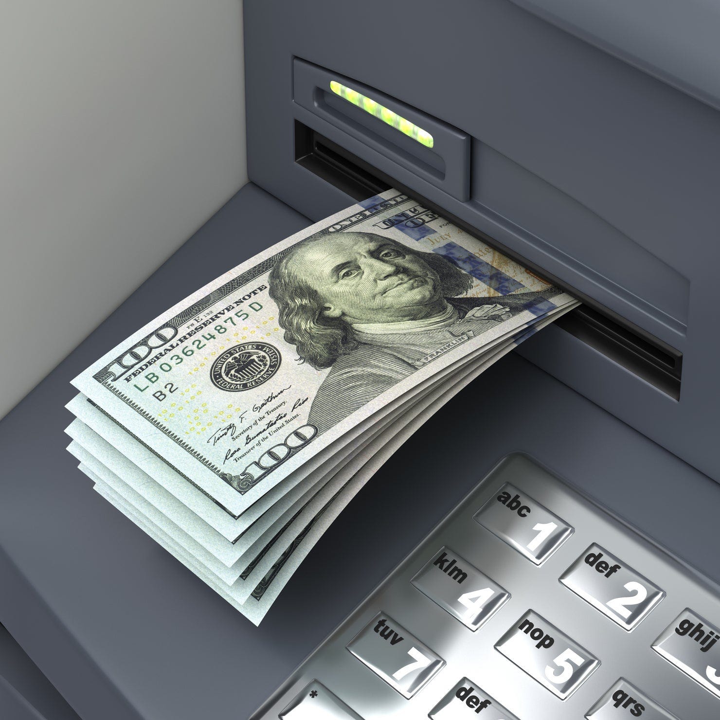 An ATM is serving up a wad of hundred-dollar bills.