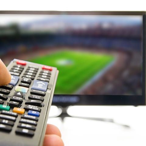 A remote control pointed at a television set