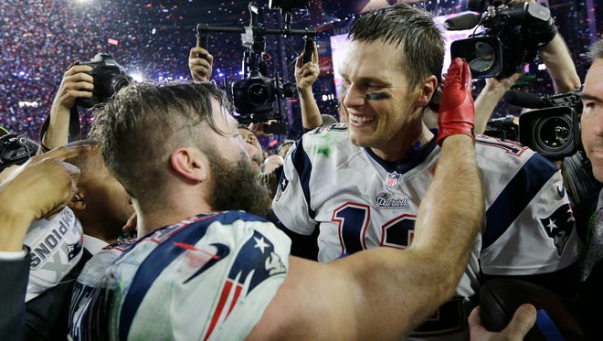 New England Patriots quarterback Tom Brady (12) celebrates with teammate Julian Edelman after the NFL Super Bowl XLIX football game against the Seattle Seahawks Sunday, Feb. 1, 2015, in Glendale, Ariz. The Patriots won 28-24.