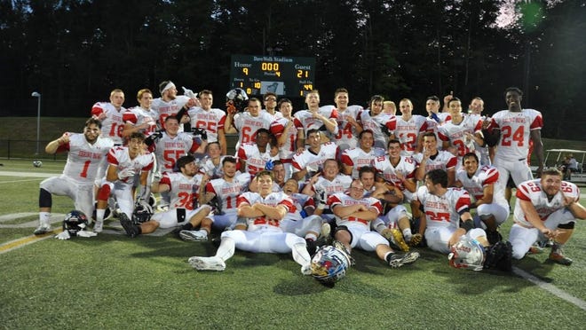 Team New Hampshire teammates celebrate after last year's 21-9 win over Vermont at Castleton College in Vermont.