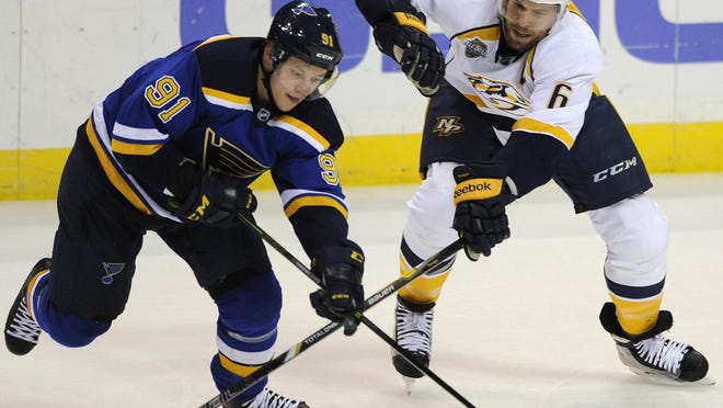 The Blues’ Vladimir Tarasenko (91) reaches in front of the Predators’ Shea Weber in the second period Thursday.