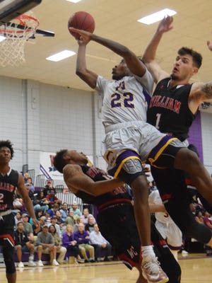 Jordan Adebutu (22, center) goes for two against William Carey defenders Brandon Cranford (1, right) and Branden Sheppard (14, left) . The Louisiana State University of Alexandria Generals won 91-72 over William Carey University Wednesday, Nov. 7, 2018 at the Fort.