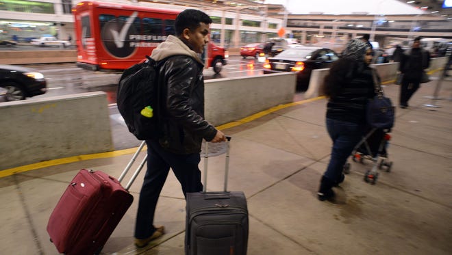 Travelers head into the terminal at Philadelphia International Airport on Nov. 26, 2014.