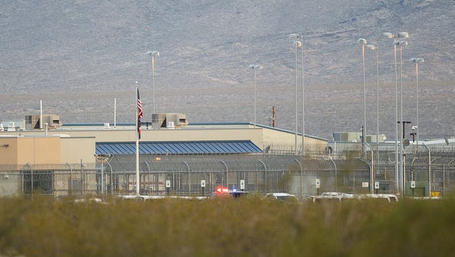 Police lights are seen in the distance after several days of unrest at the Arizona State Prison-Kingman.