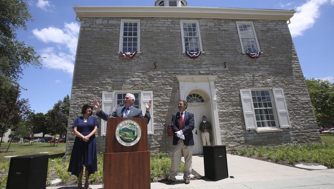 Indiana Governor Mike Pence, center, makes remarks as First Lady Karen Pence, left, and state archivist Jim Corridan look on during a bicentennial celebration at the old State Capitol in Corydon, Indiana.
June 29, 2016