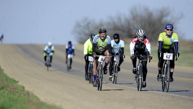 Thomas Metthe/Reporter-News Cyclists cruise down a hill on FM 18 during the Steam-N-Wheels bike race on Saturday, March 19, 2016.