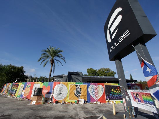 Artwork and signatures cover a fence around the Pulse nightclub, the scene of a deadly shooting on June 12, 2016.