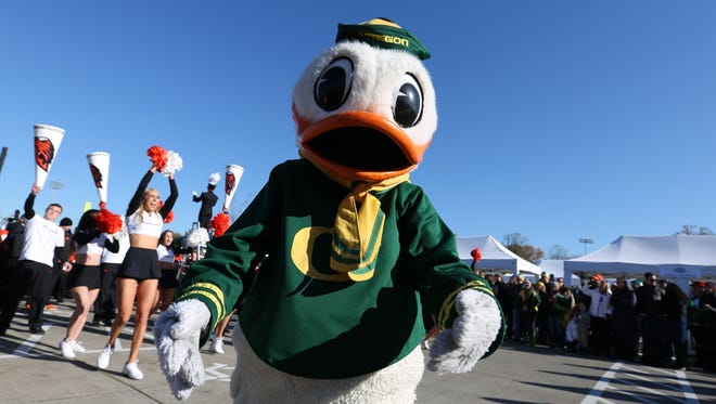 The Oregon Duck watches as Oregon State University cheerleaders face off with University of Oregon cheerleaders prior to Civil War Friday, Nov. 27, 2015, at Autzen Stadium in Eugene, Ore.