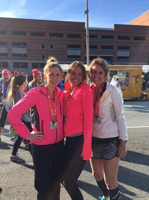 Ellen Knopf, middle, is joined by her sister Laura left, and her mom, Sue, right after the Monumental Half Marathon in Indy.