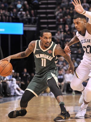 Bucks guard Brandon Jennings puts the brakes on while be guarded by Grizzlies guard Xavier Rathan-Mayes during the first half Monday.