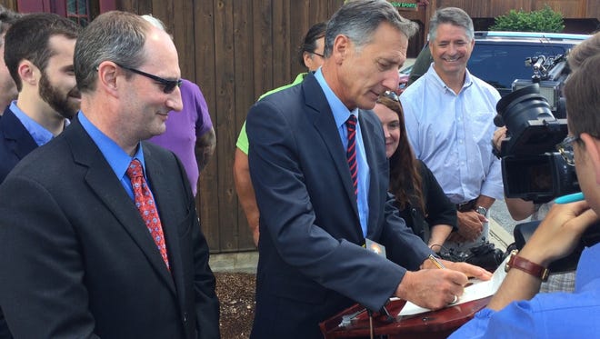 Gov. Peter Shumlin signs an executive order that will give preference in state contracting practices to companies that are using renewable energy or taking other steps to address climate change.