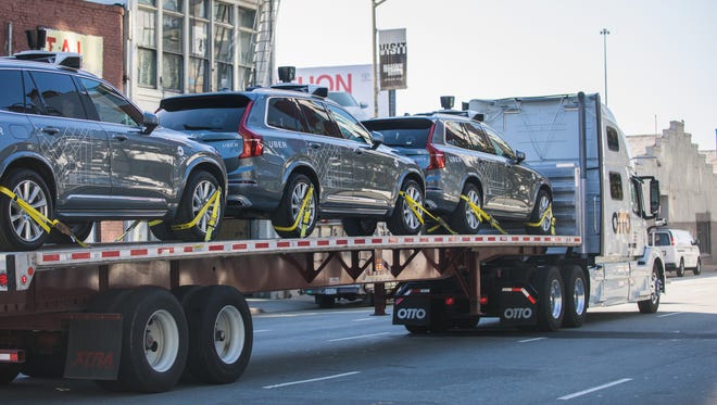 Uber provided this photo of some of its fleet of self-driving vehicles being loaded onto a truck that is heading for Arizona.