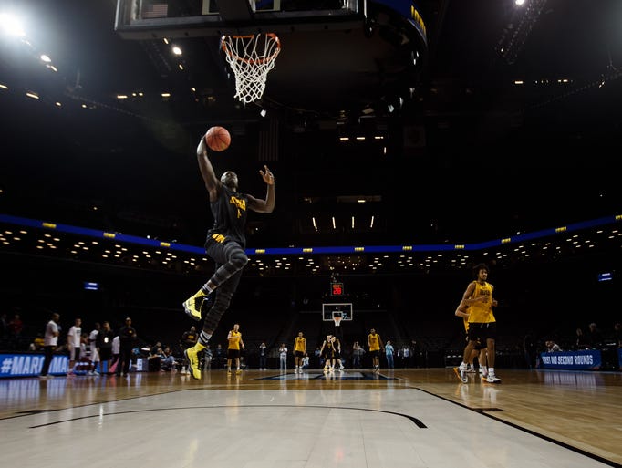 Iowa's Peter Jok dunks during Iowa's practice at the