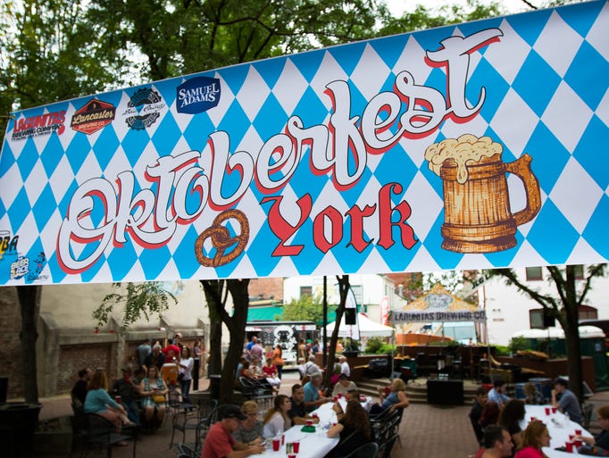 Patrons enjoy German food and beer during the Oktoberfest