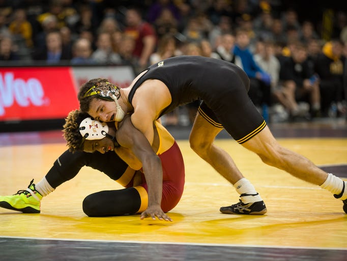 Iowa's Thomas Gilman holds down Iowa State's Markus