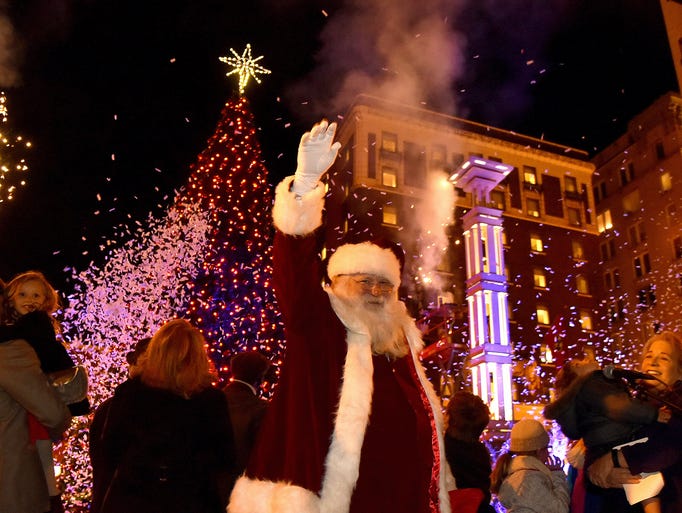 Santa Claus waves to the crowd at the lighting of the