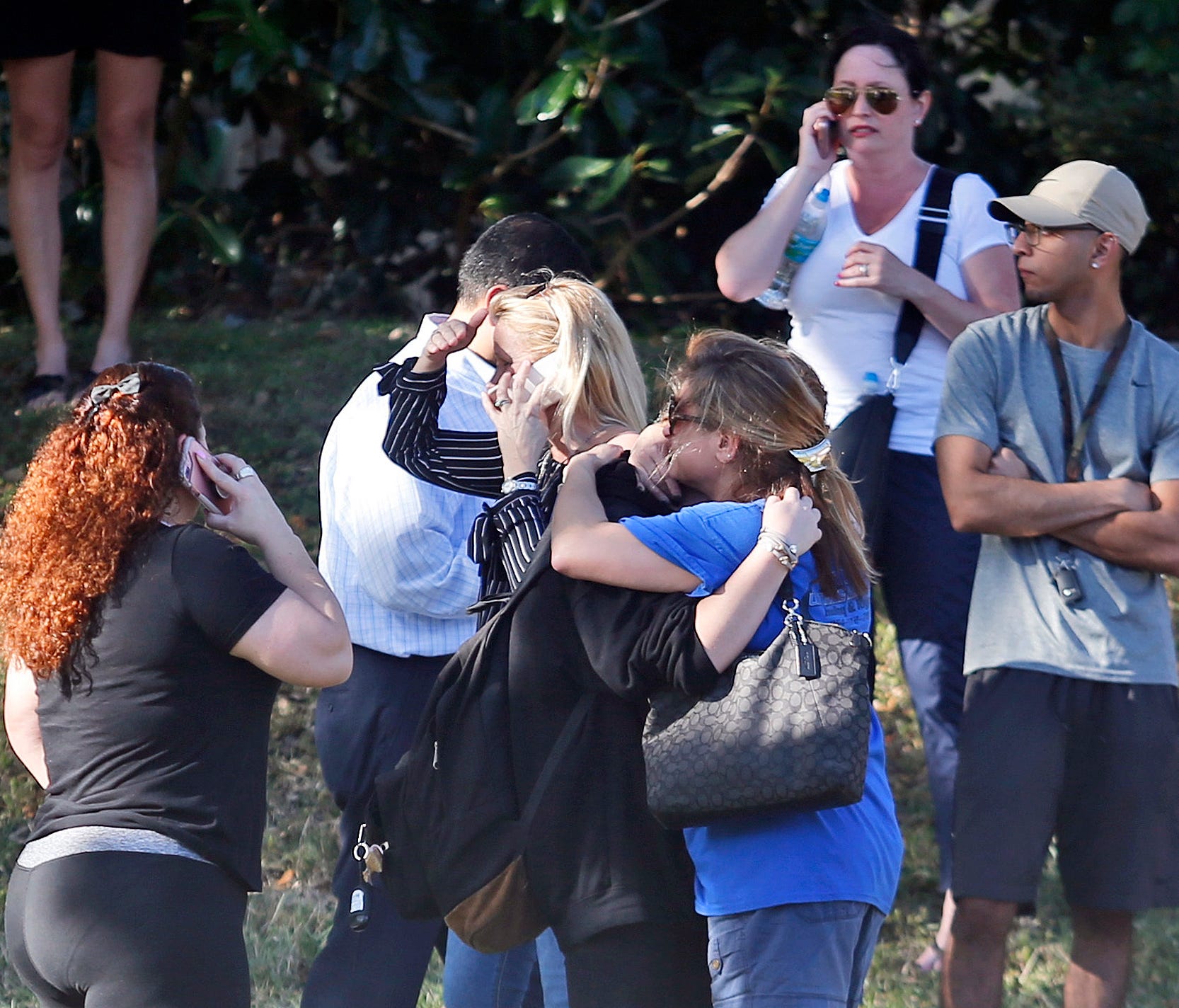 Family members wait for news of students after a school shooting.