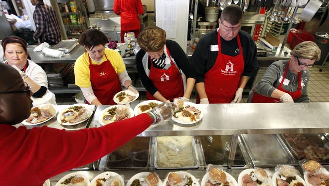2012: Volunteers from Hope Ministries prepare a Christmas meal at Bethel Mission in Des Moines.