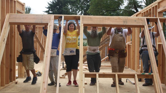 Habitat for Humanity volunteers pitch in with many skills, including at the construction site.