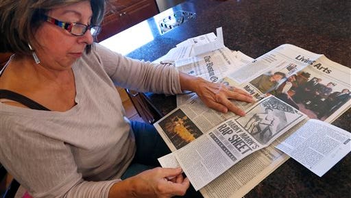 Mary Belmonte reviews newspaper clippings she had collected about Mark Wahlberg at her home in Westwood, Mass. Belmonte, a retired teacher, spoke about a 1986 incident where she was escorting 9- and 10-year-old students to Savin Hill beach when Mark Wahlberg and his friends attacked them with rocks and racial epithets. Belmonte said Wahlberg should be considered for a pardon for a separate attack two years later on a pair of Asian men, if he apologizes to his victims.