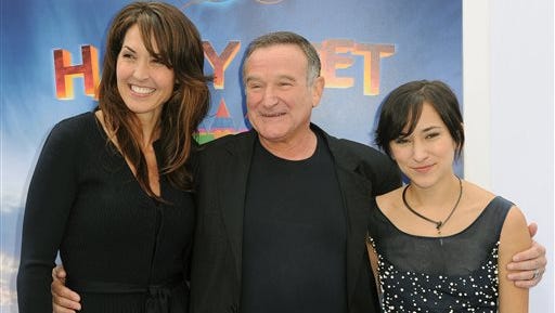 Susan Schneider, from left, Robin Williams, and Zelda Williams arrive at the premiere of  "Happy Feet Two" at Grauman's Chinese Theater, in Los Angeles. Williams' children and wife are fighting over the late comedian's estate in a California court. In papers filed in December 2014 in San Francisco Superior Court, Williams' wife, Susan, accuses the comedian's children from two previous marriages of taking items without her permission.