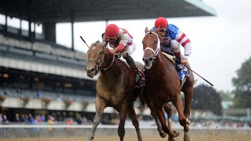 In this image provided by the New York Racing Association, Practical Joke, left, ridden by Joel Rosario, noses ahead of Syndergaard, ridden by John R. Velazquez, to win the Champagne Stakes horse race Saturday, Oct. 8, 2016, at Belmont Park in Elmont, N.Y. (Coglianese Photos/NYRA via AP)
