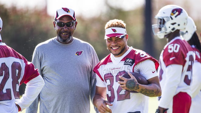 Wide receivers coach Darryl Drake, left, and Tyrann Mathieu, right, watch the Arizona Cardinals minicamp at the practice facility in Tempe, Wednesday, June 8, 2016.
