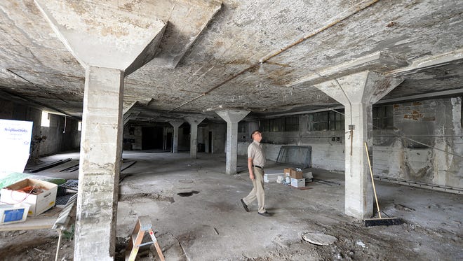 NeighborWorks project manager Tim Denissen inspects the interior of the armory building on Chicago Street that is under consideration for an urban farming operation.