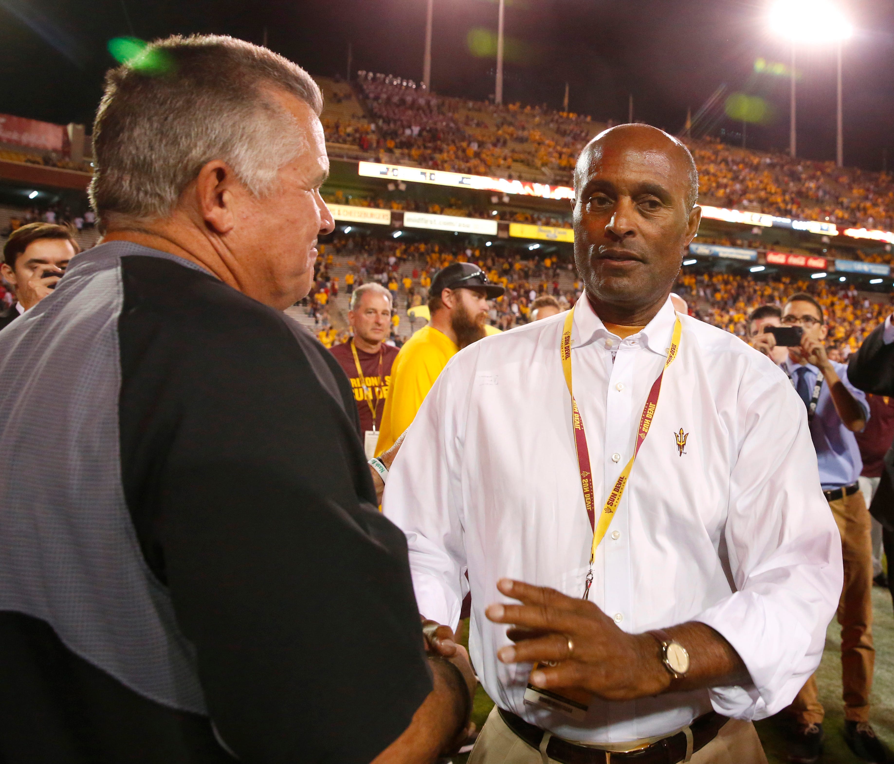 Arizona State head coach Todd Graham shake hands with Vice President for University Athletics and Athletics Director Ray Anderson after the Sun Devils won the 91st Territorial Cup game against the Arizona Wildcats at Sun Devil Stadium in Tempe on Nov