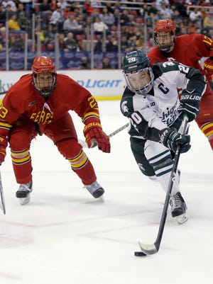 Michigan State's Michael Ferrantino (20) drives toward the goal as Ferris State's Brandon Anselmini (23) and Jared VanWormer (17) pursue during the second period of a Great Lakes Invitational college hockey game Sunday at Joe Louis Arena.