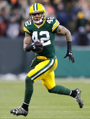 Green Bay Packers' Morgan Burnett runs after intercepting