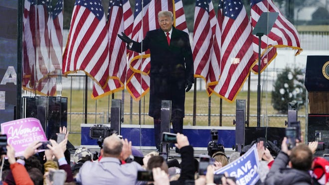 President Donald Trump greets his supporters at Wednesday’s rally in Washington. Trump is being accused of inciting violence after urging the crowd to march on the U.S. Capitol. A mob of the president’s followers pushed past Capitol security, vandalized the building and terrorized lawmakers. Five people have died in the wake of the siege.