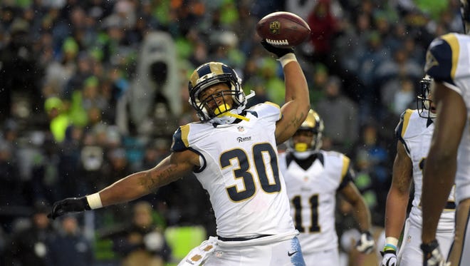 St. Louis Rams running back Todd Gurley (30) spikes the ball after scoring on a 2-yard touchdown run in the fourth quarter against the Seattle Seahawks during an NFL football game at CenturyLink Field.