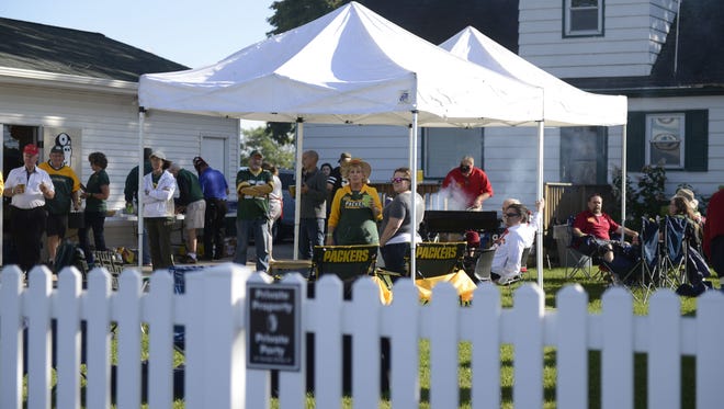 Fans tailgate at a Packers house on Stadium Drive before the Aug. 31, 2017, preseason game against the Los Angeles Rams.
