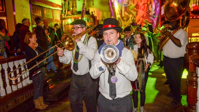 The second line procession leads the way out of Seville Quarter to begin the Wind Creek Pensacola Mardi Gras Kick Off Celebration in downtown Pensacola.