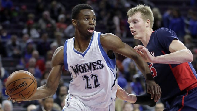 Andrew Wiggins looks to pass the ball against Kyle Singler on Sunday night.