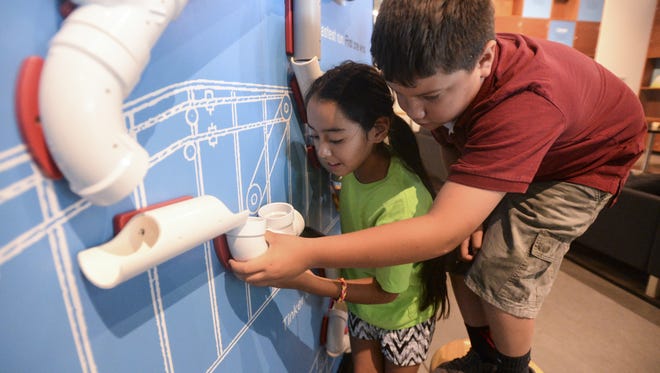 Jocelyn Mendoza and Jair Solano, right, check out an exhibit at the Museum of Discovery. They attend The Family Center nonprofit child-care center, which received a $30,000 Pharos Fund grant this spring.
