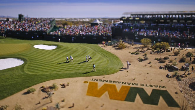 Players walk to the 16th green during the final round of the Waste Management Phoenix Open golf tournament at TPC Scottsdale in Scottsdale, Az., on Sunday, February 7, 2016.