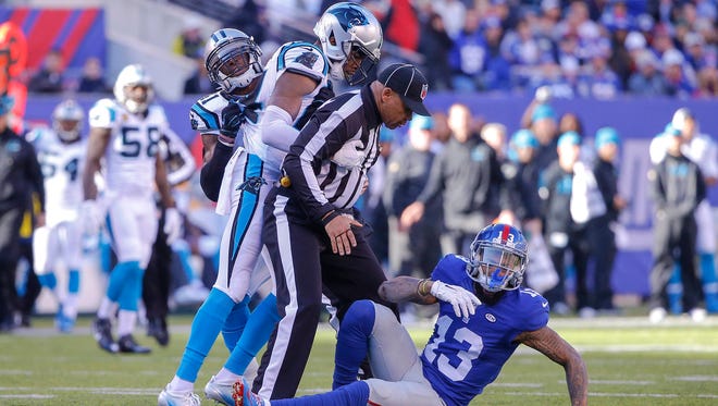 New York Giants wide receiver Odell Beckham (13) gets thrown to ground by Carolina Panthers cornerback Josh Norman (24) during the first quarter at MetLife Stadium.