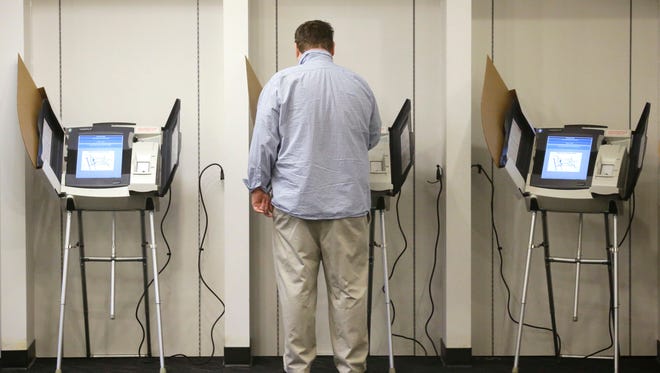 In this Nov. 3, 2015, file photo, a person votes, in Salt Lake City. Utah voters this month will pick candidates in key races for governor and U.S. Senate and narrow the field in dozens of other races. More than two-thirds of Utah counties are conducting the June 28 primary election mostly by mail.