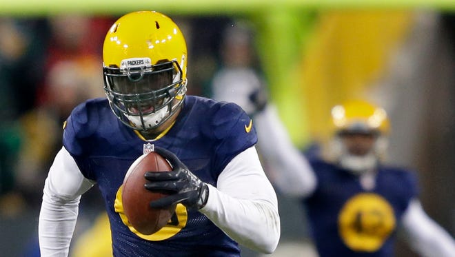 Green Bay Packers linebacker Julius Peppers runs for a touchdown after intercepting a pass from Philadelphia Eagles quarterback Mark Sanchez during their game at Lambeau Field in November 2014.