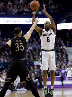 Michigan State guard Cassius Winston, right, shoots over Northwestern guard Aaron Falzon during the first half on Saturday, Feb. 17, 2018, in Rosemont, Ill.