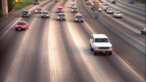 FILE- A white Ford Bronco, driven by Al Cowlings and carrying O.J. Simpson, is trailed by police cars as it travels on a southern California freeway on June 17, 1994, in Los Angeles. Cowlings and Simpson led authorities on a chase after Simpson was charged with two counts of murder in the deaths of his ex-wife and her friend.