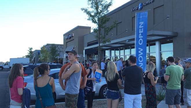 Diners form a line outside the grand opening party of Torchy's Tacos  at the Foothills shopping center in Midtown Fort Collins.