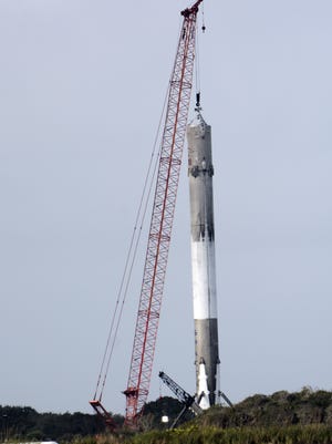 The first stage of a SpaceX Falcon rocket sits on Pad 13 at Cape Canaveral Air Force Station. The media got a closer look at the rocket that SpaceX successfully landed the night before.