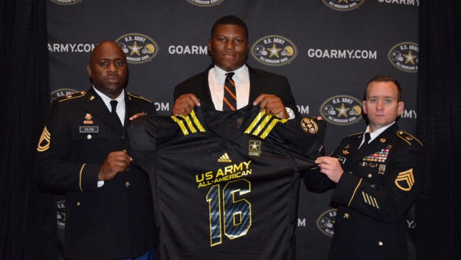 Derrick Brown receiving his U.S. Army All-American Bowl jersey alongside (from left to right) are Sergeant First Class John Fulton and Staff Sergeant Brian Snetana. Brown will be on Auburn's campus this weekend.